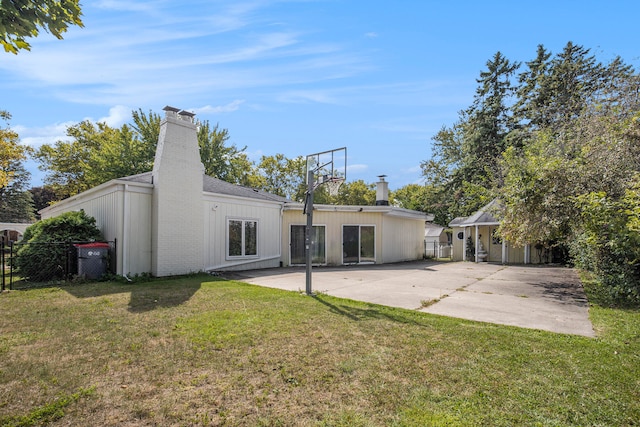 rear view of house with a patio area and a yard