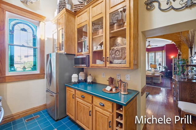 kitchen featuring ceiling fan, dark wood-type flooring, and appliances with stainless steel finishes