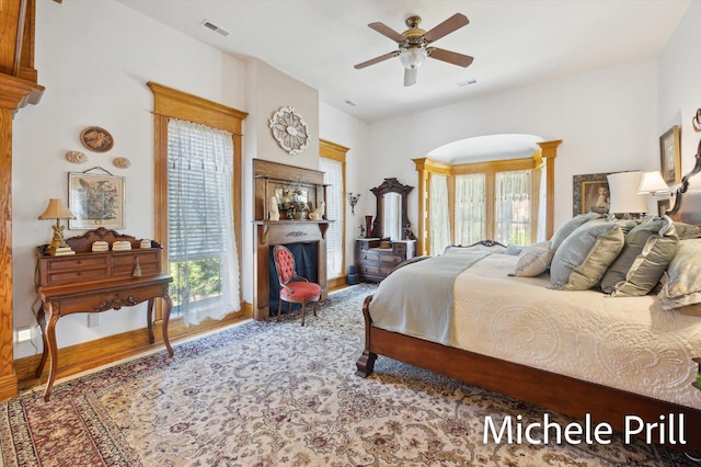 bedroom with multiple windows and ceiling fan