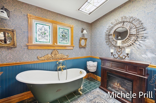 bathroom featuring a bathing tub, wood walls, and tile patterned floors