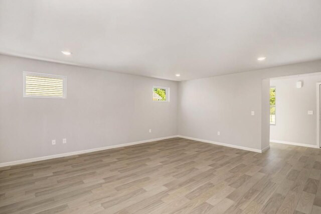 spare room featuring light hardwood / wood-style floors and a wealth of natural light