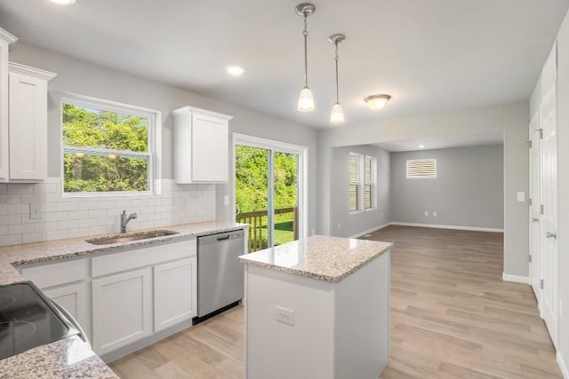 kitchen featuring dishwasher, light hardwood / wood-style floors, white cabinetry, and sink