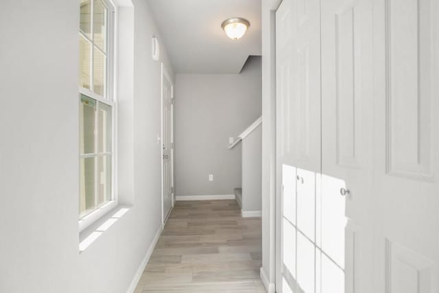 corridor with light hardwood / wood-style flooring