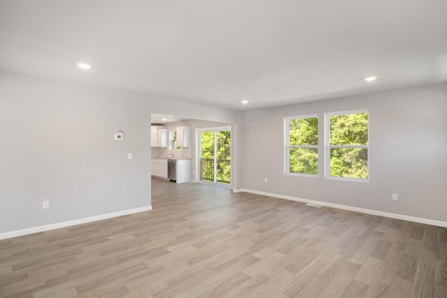 unfurnished living room with light hardwood / wood-style flooring