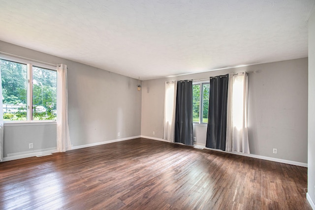 unfurnished room featuring dark wood-type flooring