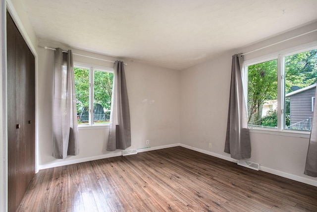 spare room with dark hardwood / wood-style floors