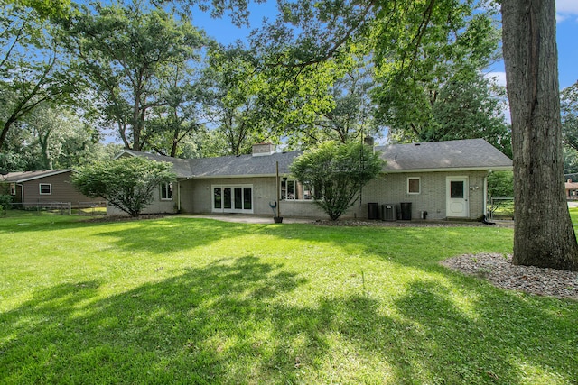 back of house with a lawn, a patio area, and cooling unit