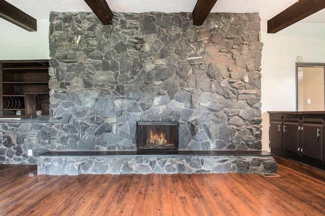 details with beamed ceiling, a fireplace, and hardwood / wood-style floors