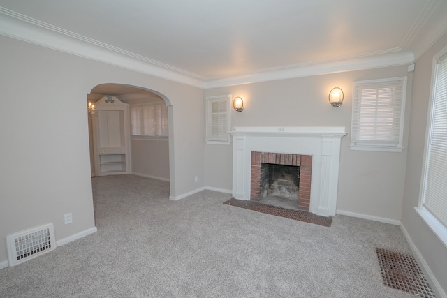 unfurnished living room featuring ornamental molding, light colored carpet, and a fireplace