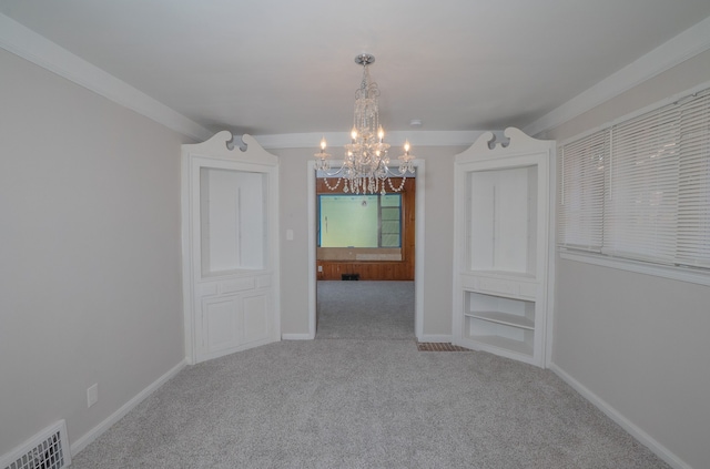 unfurnished dining area with crown molding, carpet, a notable chandelier, and built in shelves