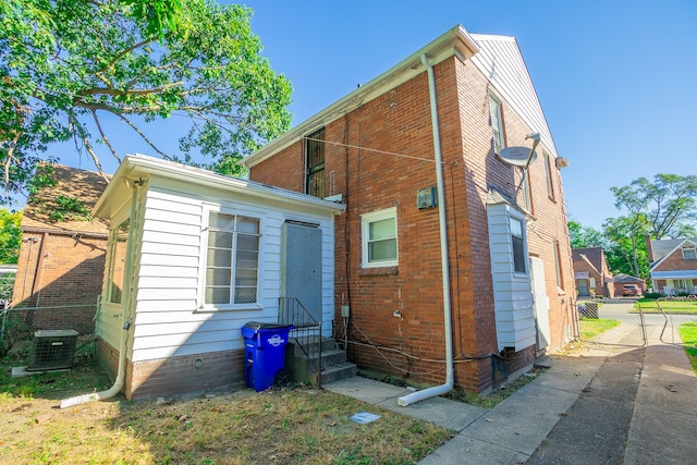 rear view of property with cooling unit