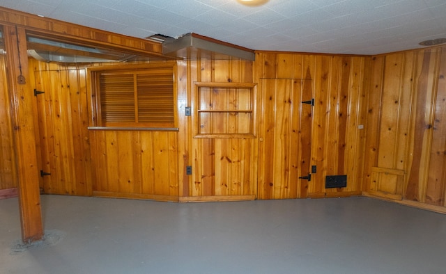 basement featuring wood walls