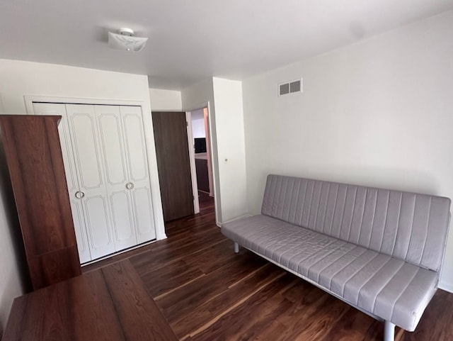 sitting room with dark wood-type flooring