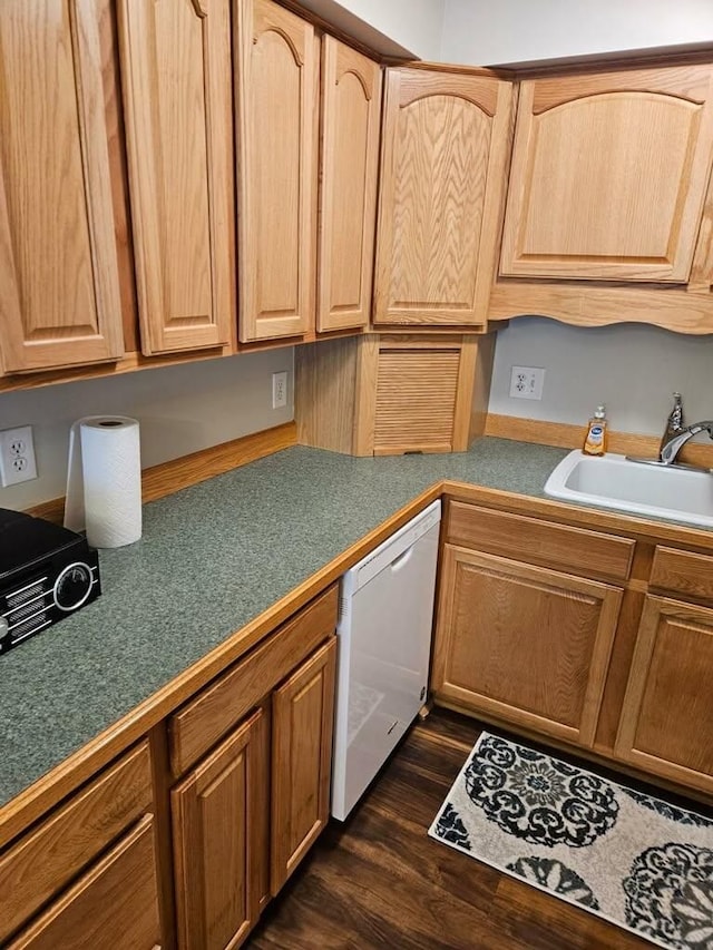 kitchen with dishwasher, sink, and dark hardwood / wood-style floors