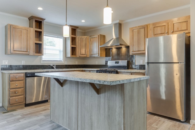 kitchen with wall chimney range hood, crown molding, light hardwood / wood-style flooring, appliances with stainless steel finishes, and decorative light fixtures