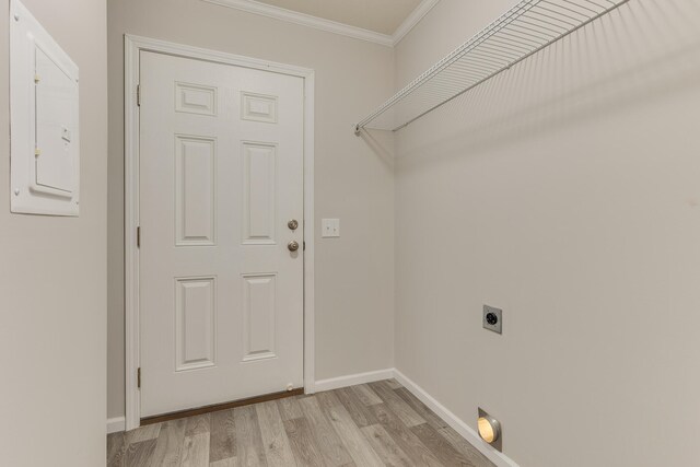 laundry room featuring ornamental molding, light wood-type flooring, electric panel, and electric dryer hookup