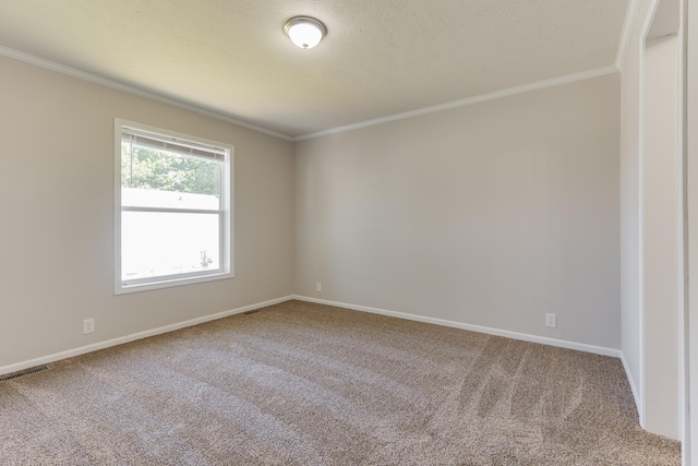 empty room featuring a textured ceiling, carpet floors, and crown molding