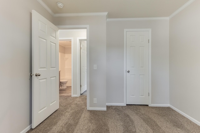 unfurnished bedroom featuring carpet floors and crown molding