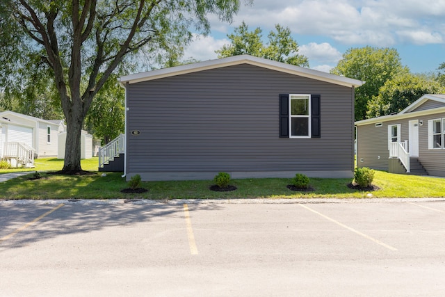 view of side of property with a lawn