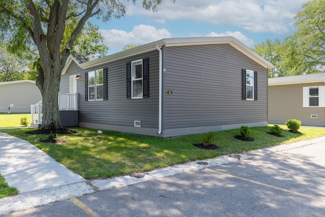 view of side of property with a lawn