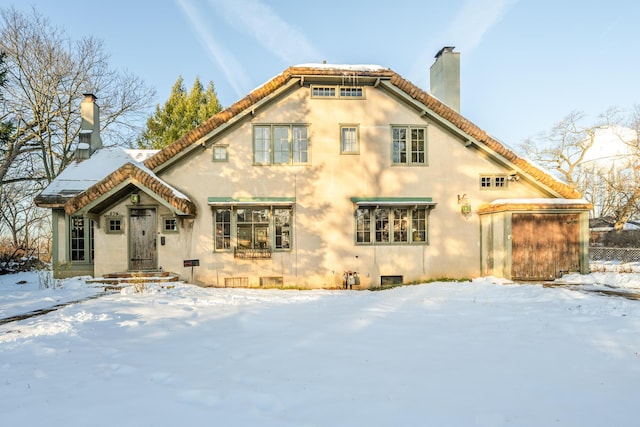 view of snow covered back of property