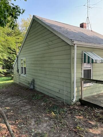 view of property exterior with a deck