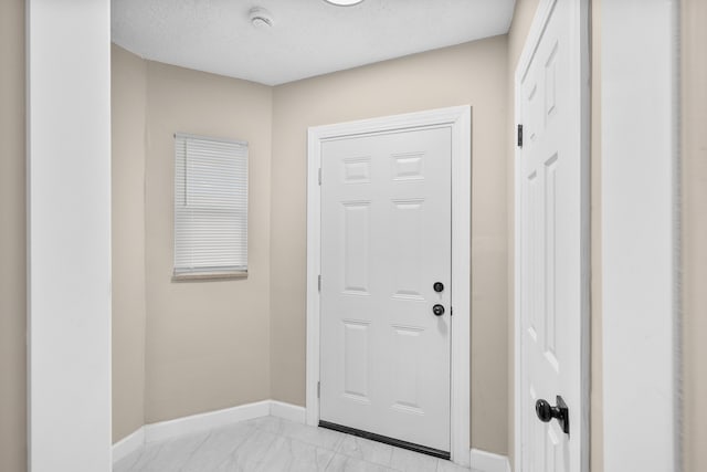 entryway with a textured ceiling