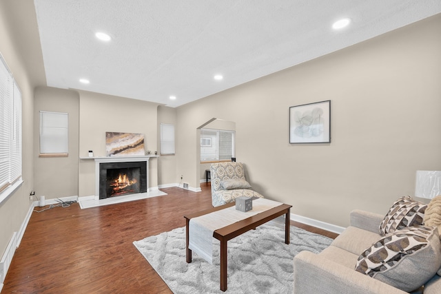 living room with hardwood / wood-style floors and a textured ceiling