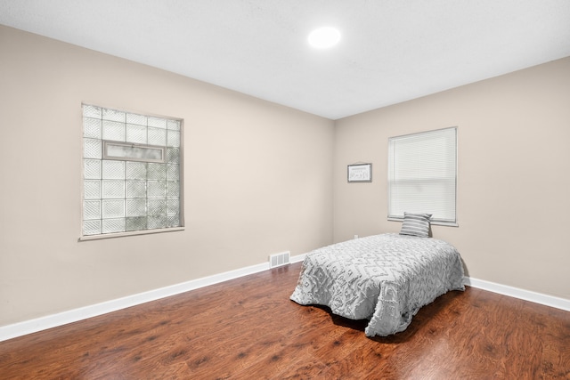 bedroom with hardwood / wood-style flooring