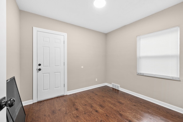 unfurnished room featuring dark hardwood / wood-style flooring