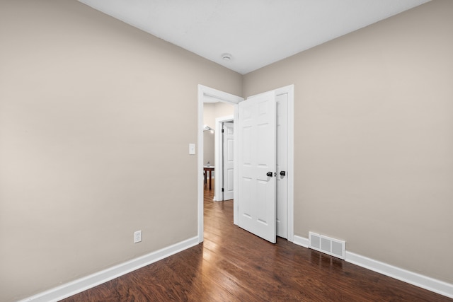 spare room featuring dark hardwood / wood-style flooring