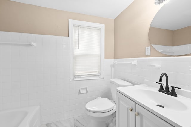 bathroom featuring vanity, toilet, tile walls, and a bathing tub