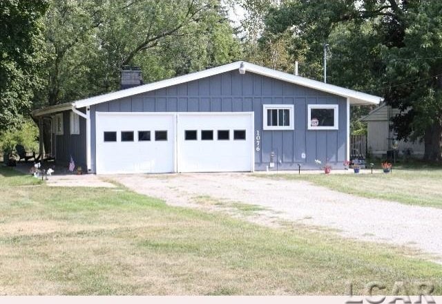 garage featuring a lawn