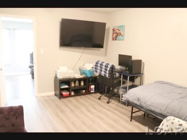 bedroom with light wood-type flooring