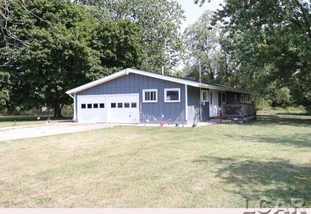 single story home with a front lawn and a garage