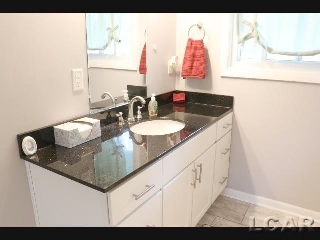 bathroom featuring tile patterned flooring and vanity