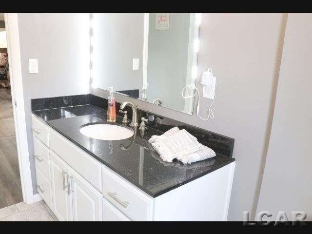 bathroom with tile patterned floors and vanity