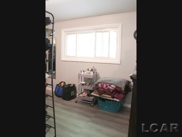 clothes washing area with hardwood / wood-style floors