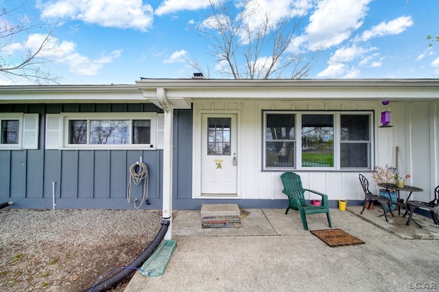 entrance to property with a porch and board and batten siding