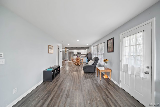 interior space with dark wood-type flooring, baseboards, and recessed lighting