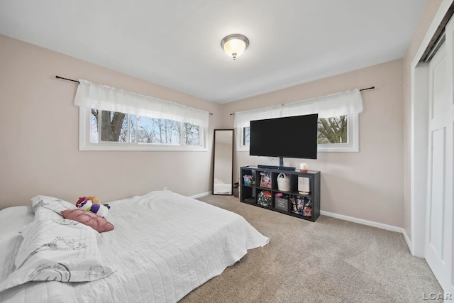 bedroom with carpet, a closet, and baseboards