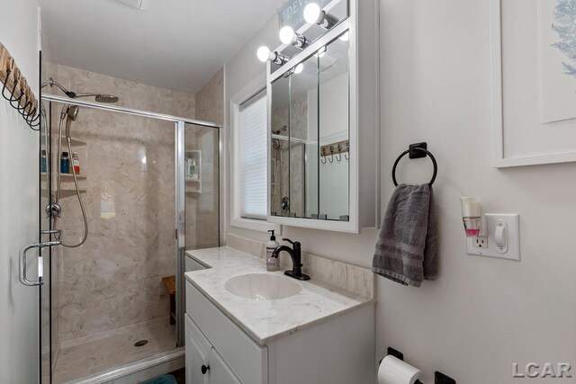 bathroom with vanity and a shower with shower door