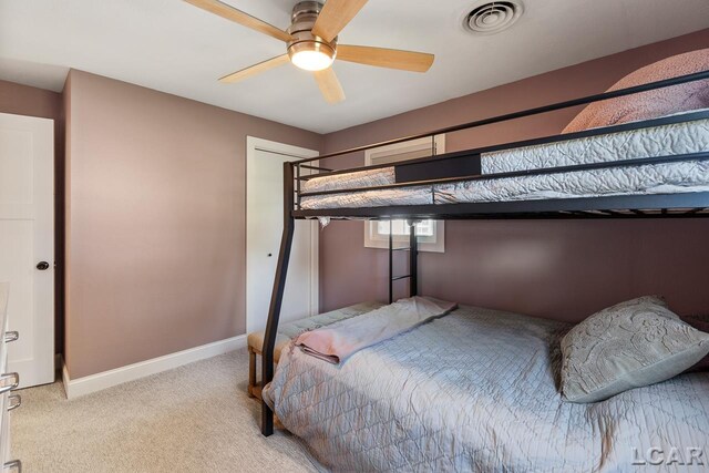 bedroom with ceiling fan and light carpet