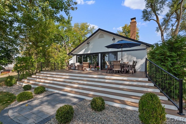 rear view of property featuring a deck