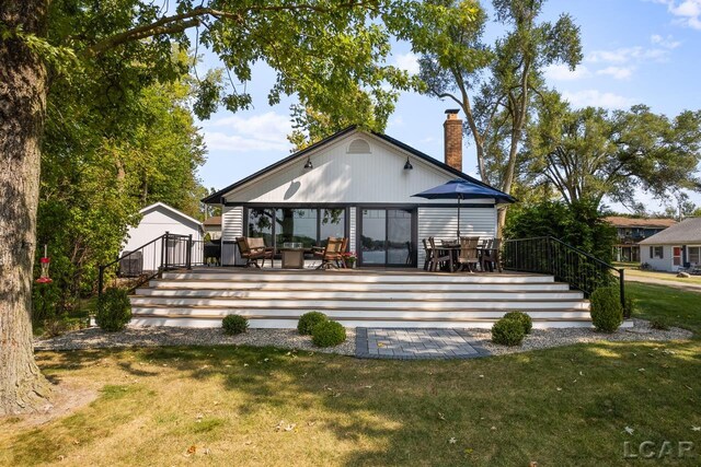 rear view of property with a patio area and a yard