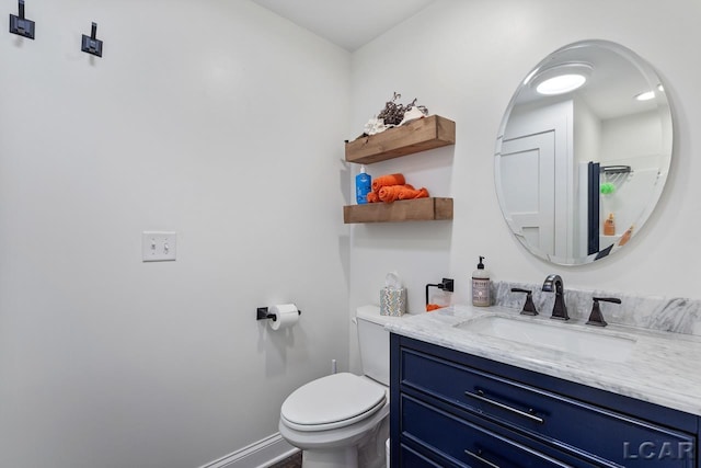 bathroom featuring vanity and toilet