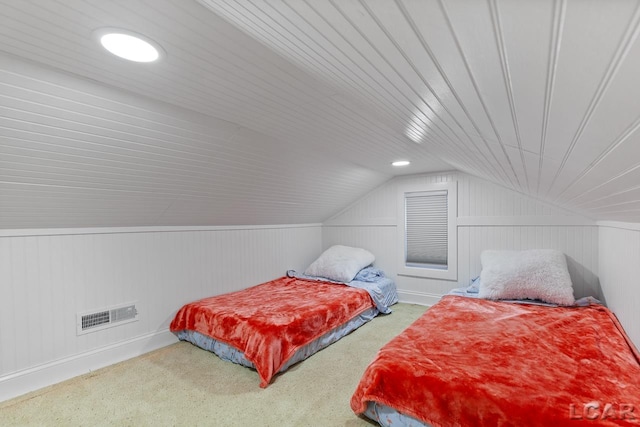 bedroom with carpet floors and lofted ceiling