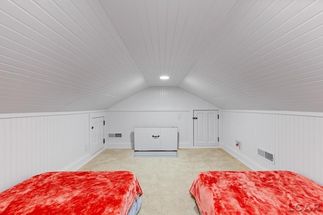 carpeted bedroom with lofted ceiling