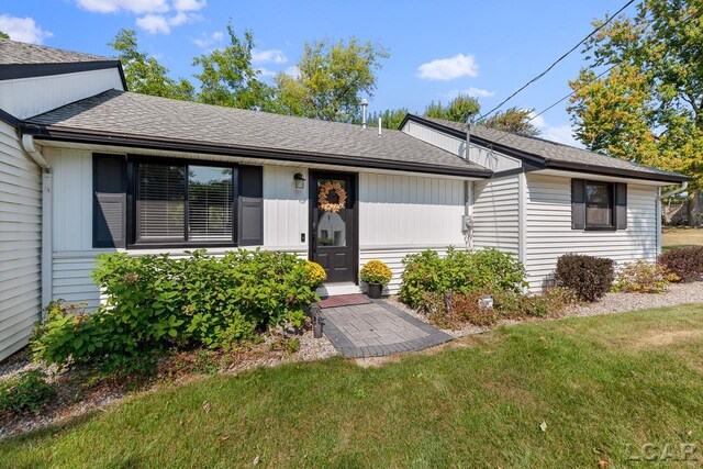 6103 Highland Ave, Manitou Beach, MI 49253 - single story home with a front lawn and roof with shingles