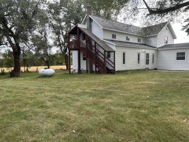 13664 Wabasis Ave NE, Cedar Springs, MI 49319 - rear view of property featuring stairs, a yard, a wooden deck, a chimney, and roof with shingles